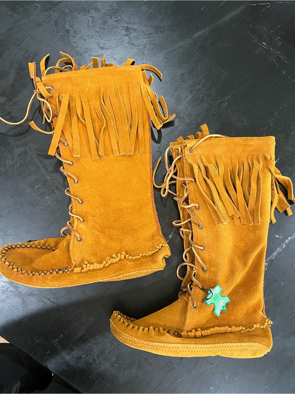 Women’s Fringe Lace-Up Moccasin Boots. No size indicated. Never worn.